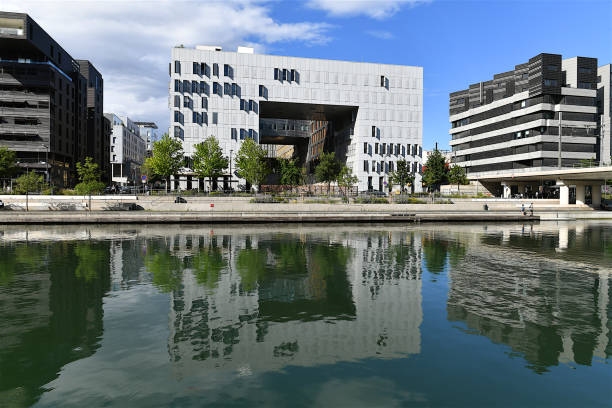 Lyon, France-06 24 2022: Reflection in water of a modern building in the Confluence district in Lyon, France.