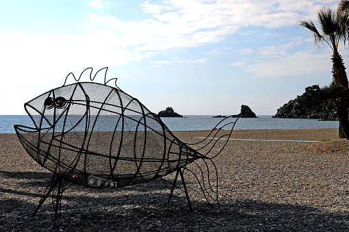 Bin in shape of fish on beah of Almunecar Spain