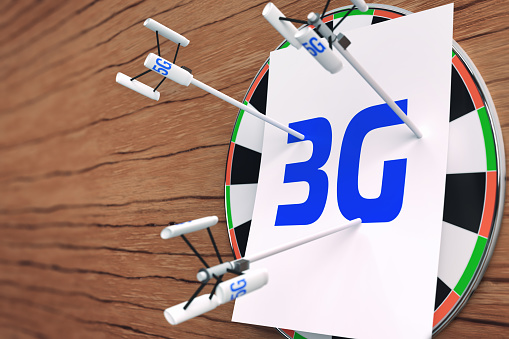 An illustration with a darts board and darts stuck into a sheet with the inscription 3G in the form of cell towers with the inscription 5G. Replacing obsolete mobile communication technologies.