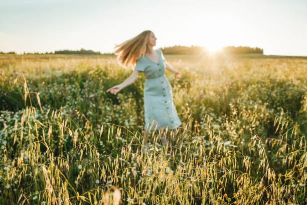 istock Woman dance in the field on sunset. 1406730285