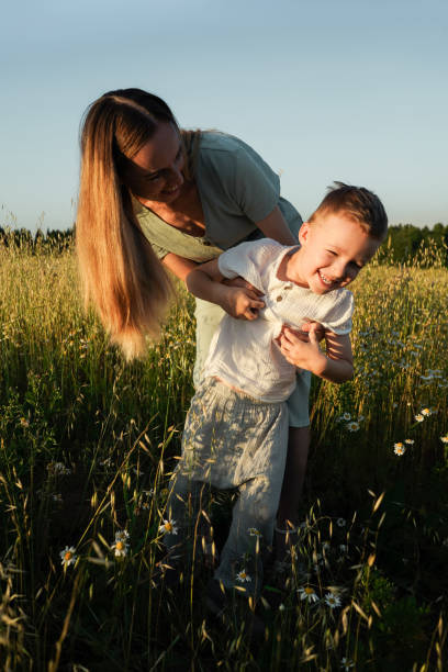istock Mother and son play in the field. 1406730297