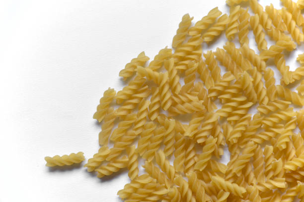 istock Twisted raw pasta on a white background close-up 1406731900
