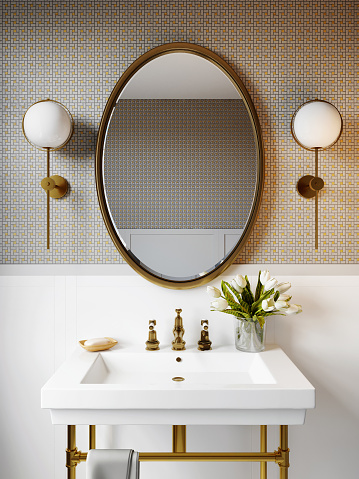 Interior of a modern bathroom with a wall with a mosaic of white and gold colors. Round mirror and square washbasin on a white shelf. Spa treatments and a bouquet of white tulips. 3d rendering