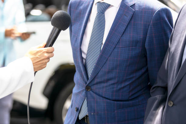 istock Reporter making media or press interview, female hand holding microphone 1406733347