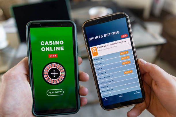 Smart Phone Betting A close-up shot of an unrecognisable man and woman sitting indoors, they are holding smart phones in their hand and they are using them to gamble in an online casino and sports bet online. sports betting stock pictures, royalty-free photos & images