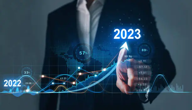 Photo of Businessman draws increase arrow graph corporate future growth year 2022 to 2023. Planning,opportunity, challenge and business strategy. New Goals, Plans and Visions for Next Year 2023.