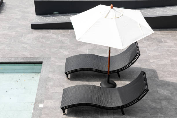 istock Relaxing chairs beside swimming pool 1406744783