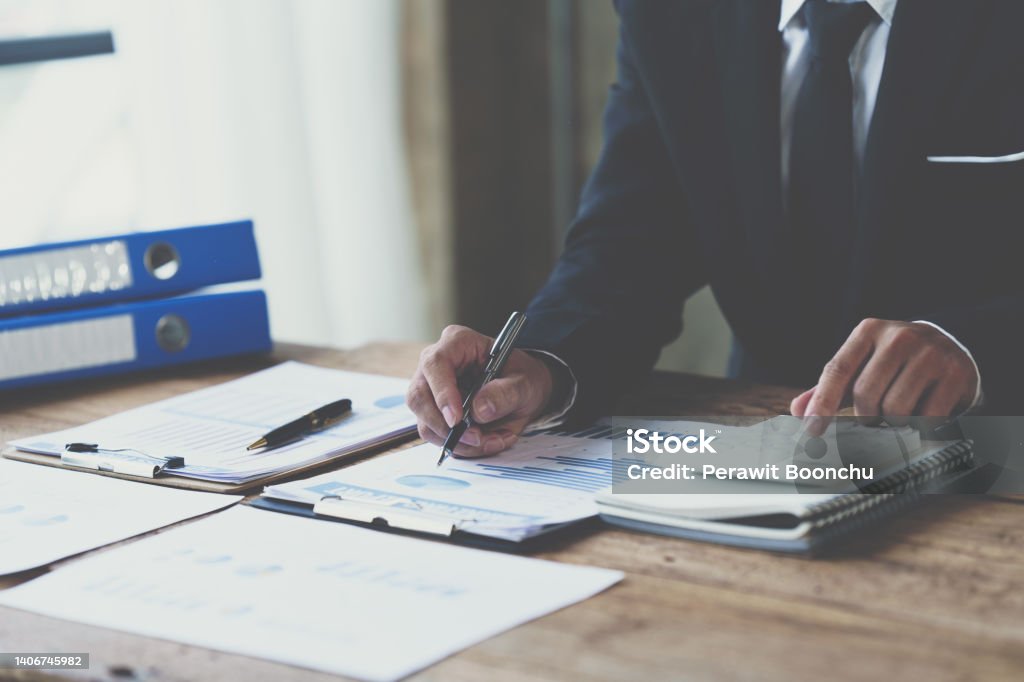 Businessman analysis marketing plan, Accountant calculate financial report, Accounting Calculating Cost Economic Financial data. Internal Revenue Service Stock Photo