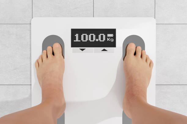 istock Legs staying on electronic floor scales 3D 1406746811