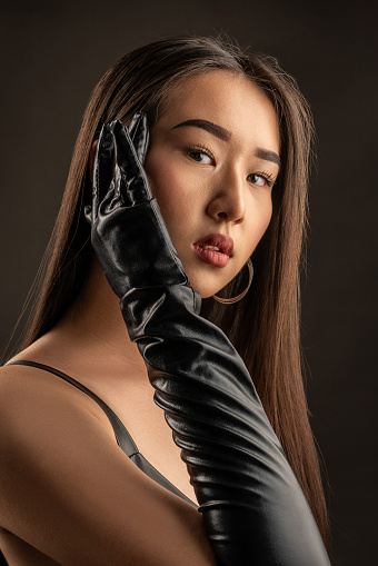 Portrait of a beautiful Asian girl on a dark background