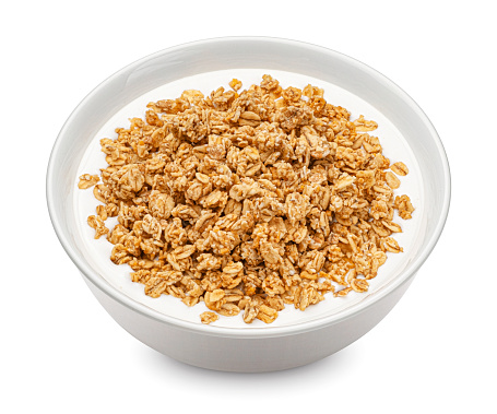 Oat granola with milk isolated on white background, full depth of field