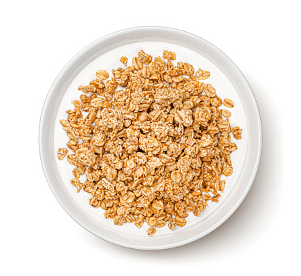 Oat granola with milk isolated on white background, top view, full depth of field