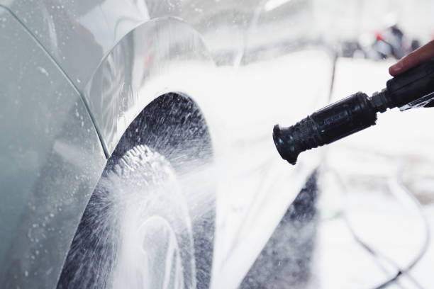 istock Unrecognizable woman washing a car. 1406749867