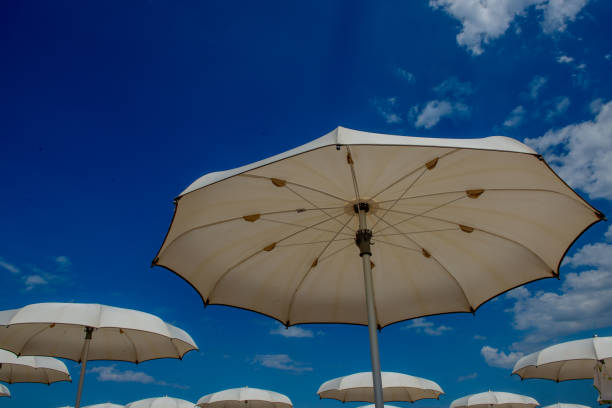 istock White umbrellas open on the beach 1406752050