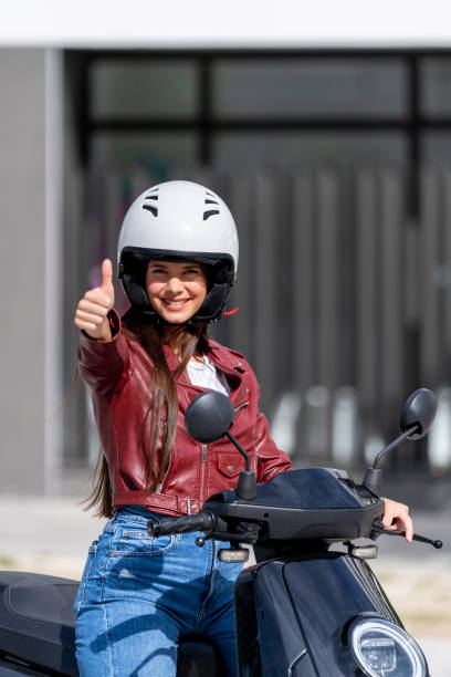 istock Woman on motorcycle making an ok gesture 1406753430