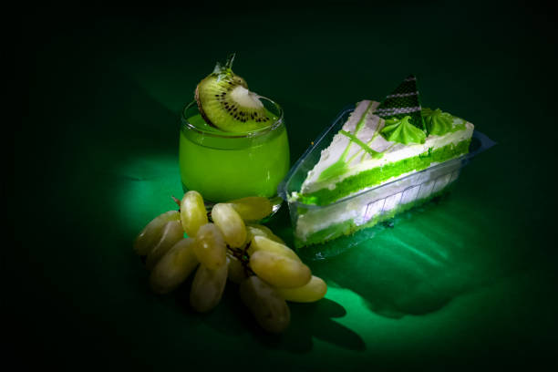 istock Dessert. pastry, mango drink, green grapes on dark background. bright. macro. close up 1406753482