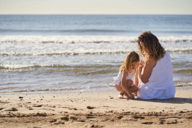 istock a woman with her daughter by the seashore 1406755600