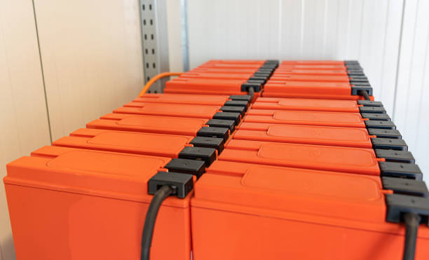 istock Batteries on shelves connected to a large UPS battery 1406761291