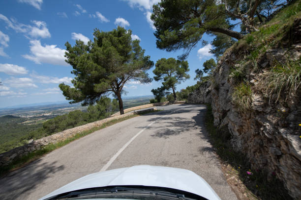 Traveling by car in sunny weather on the serpentine roads of Mallorca.