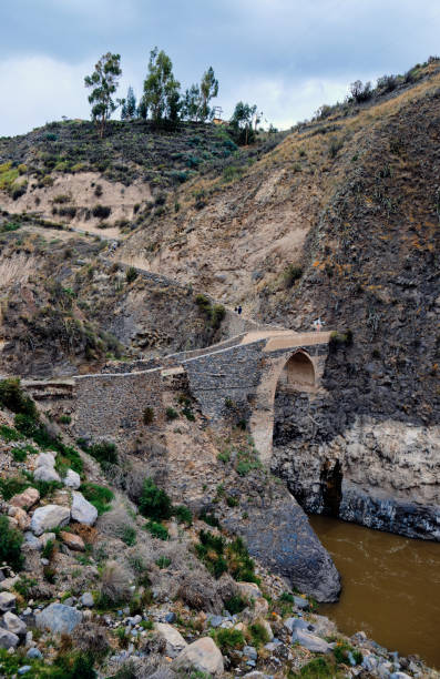istock Stone bridge over a river in the Andes. 1406763248