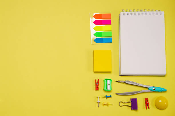 istock Notebook on a spring for notes and stationery lie on a yellow background 1406763461