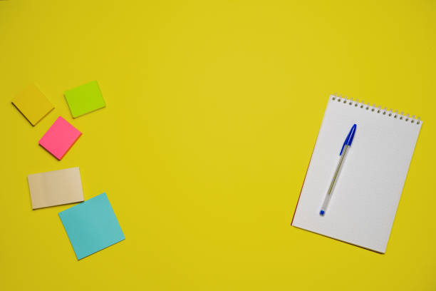 istock Notebook and pen on a yellow background. Top view with copy space. Stationery 1406763514