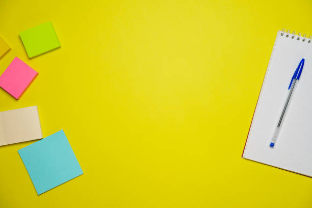 istock Top view photo open notepad ballpoint pen on yellow background with copy space. 1406763534