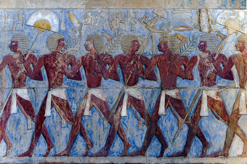 Painted bas-relief depicting a festival procession of soldiers from the at the mortuary temple of Queen Hatshepsut . Luxor .Egypt .