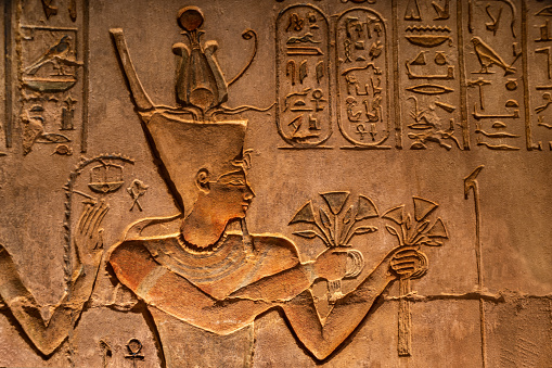 the pharaoh presenting flowers at the temple of Deir el Medina. Luxor .Egypt.