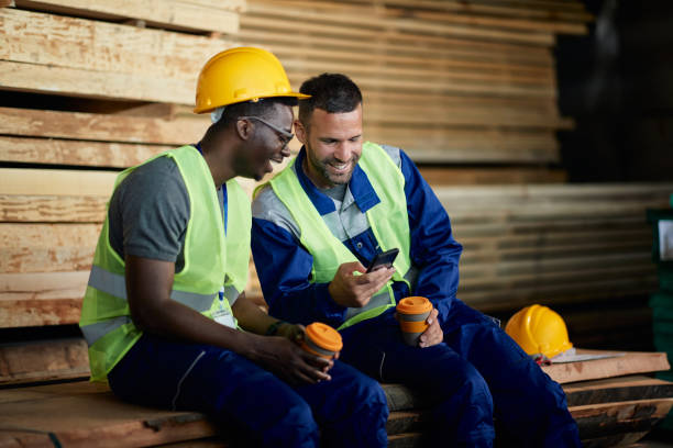 istock Happy warehouse worker and his black colleague using smart phone during their coffee break. 1406766308