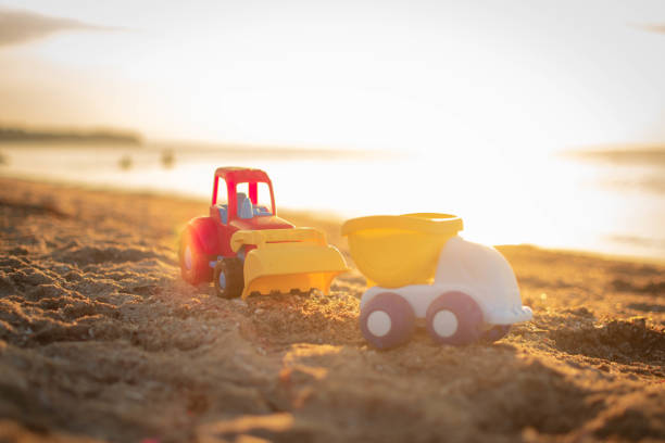 istock Excavation vehicles (toys) on the beach. 1406766331