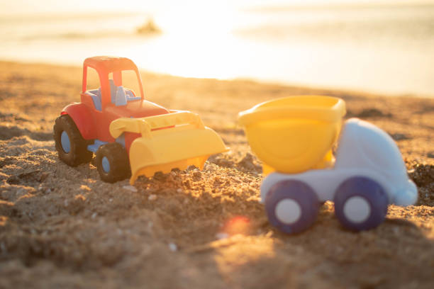 istock Excavation vehicles (toys) on the beach. 1406766336