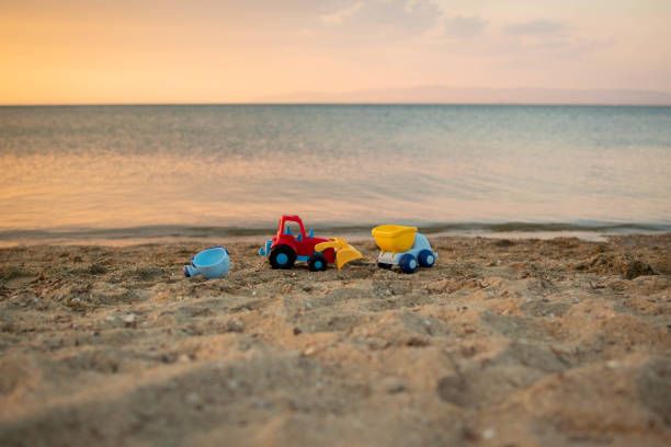 istock Excavation vehicles (toys) on the beach. 1406766355