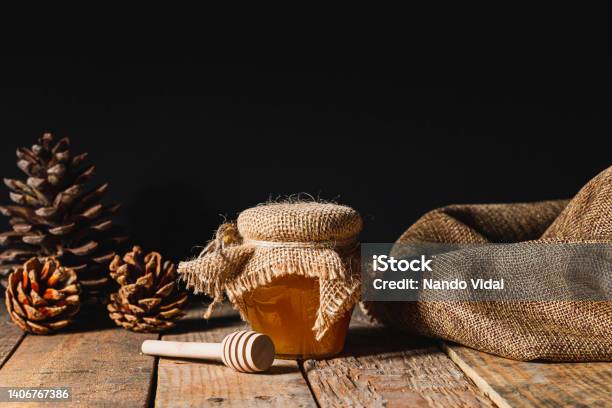 Honey Jar On A Rustic Wooden Table Stock Photo - Download Image Now - Pine Cone, Syrup, Black Color