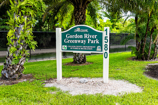 Naples, USA - September 10, 2021: Naples in Southwest Florida Coller County with sign entrance to Gordon River Greenway Park through mangrove swamp and boardwalk trail
