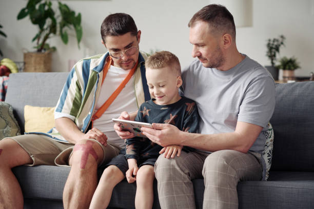 istock Gay parents with adopted son at home 1406769245