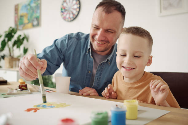 istock Father painting a picture with his son 1406769979