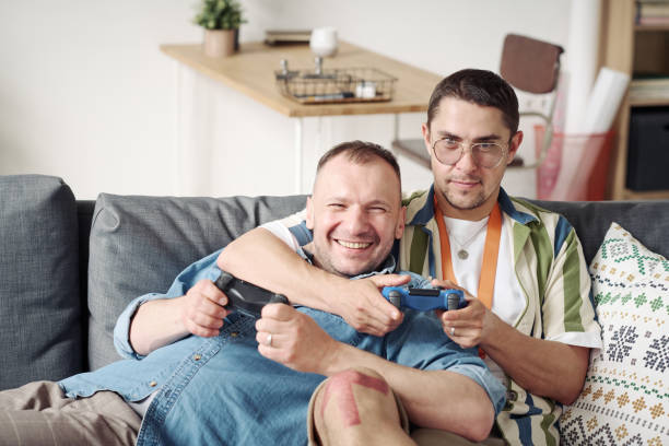 istock Gay couple playing game console 1406770036