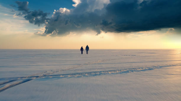 istock The two backpackers trekking through the icy snow field 1406770139