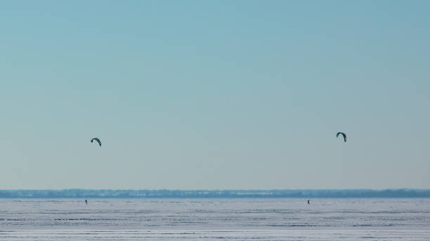 istock The two people doing snowkiting on the icy snow field 1406770151