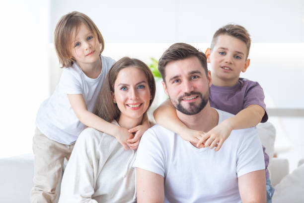 Happy family with children on sofa stock photo