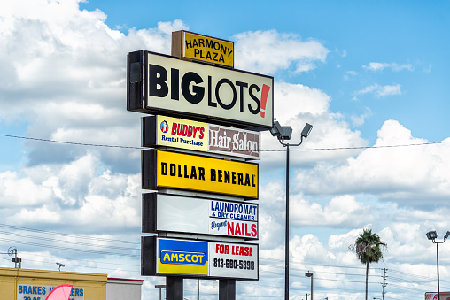 Port Richey, USA - October 4, 2021: Florida city on gulf coast with sign for Big lots cheap discount store for groceries and home goods on Harmony plaza with Dollar General, Amscot and hair salon