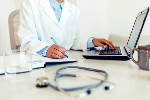 istock Doctor working on laptop computer in modern clinics office 1406772201