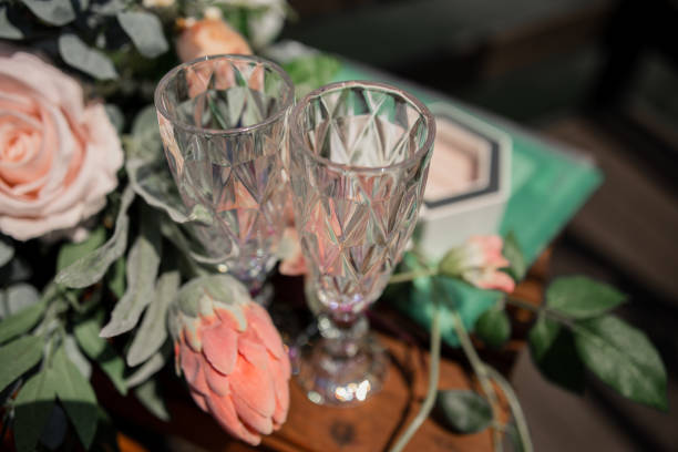 istock faceted glasses empty on the table with flowers for the holiday wedding anniversary 1406774342