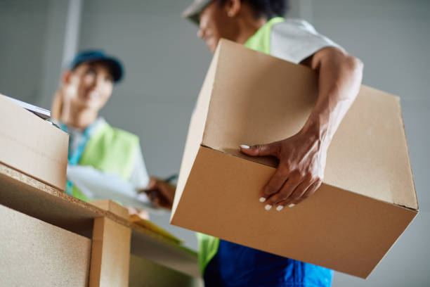 istock Close up of worker signing distribution paperwork while working at storage compartment. 1406774409