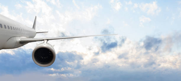 istock Flying airplane in blue sky clouds background 1406774811