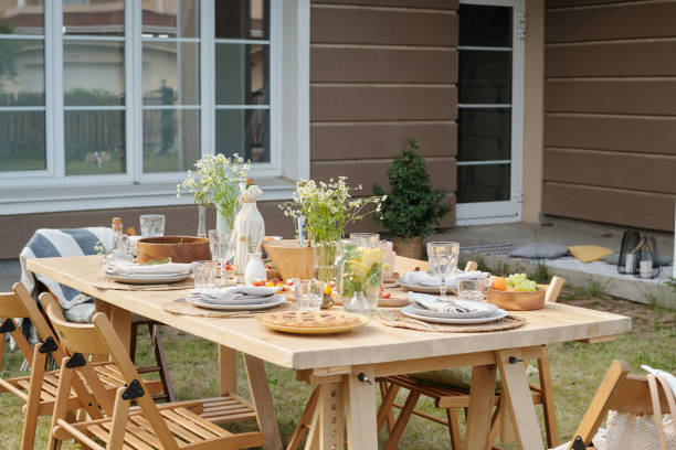 istock Served table with food, drinks, glasses, plates, wildflowers and other stuff 1406775011