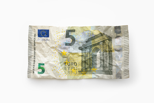 Crumpled €5 note against a white background