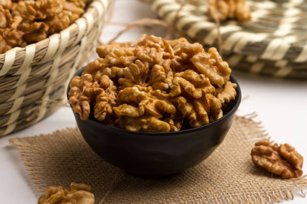istock walnut served in a bowl isolated on napkin side view of nuts on grey background 1406776083