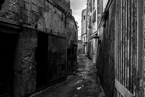 An empty path with old derelict houses in the center of Gargano, Italy